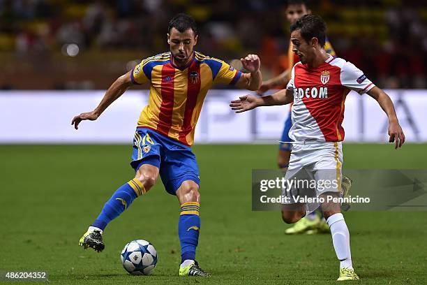 Javi Fuego of Valencia is challenged by Bernardo Silva of Monaco during the UEFA Champions League qualifying round play off second leg match between...