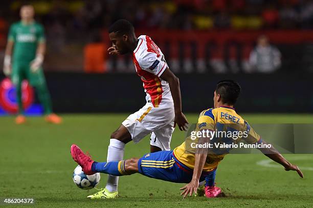 Thomas Lemar of Monaco is tackled by Enzo Perez of Valencia during the UEFA Champions League qualifying round play off second leg match between...