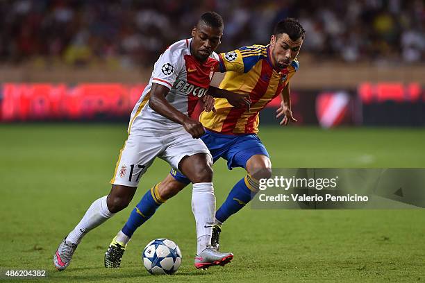 Ivan Cavaleiro of Monaco is challenged by Javi Fuego of Valencia during the UEFA Champions League qualifying round play off second leg match between...