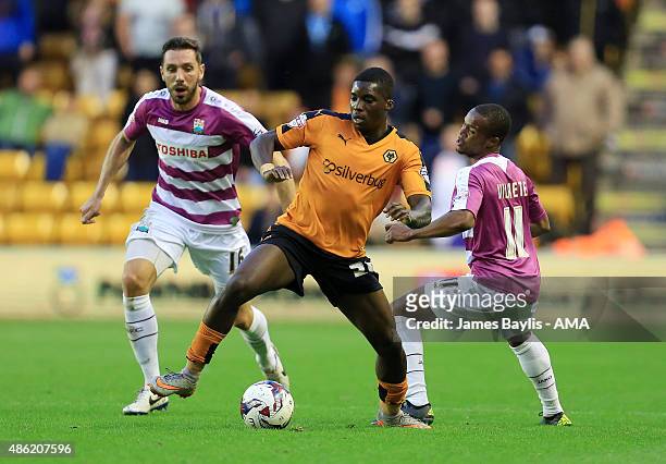 Sheyi Ojo of Wolverhampton Wanderers and Mauro Vilhete and Tom Champion of Barnetduring the Capital One Cup match between Wolverhampton Wanderers and...
