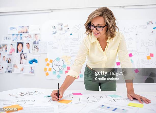 woman drawing a business plan - evolution woman stockfoto's en -beelden