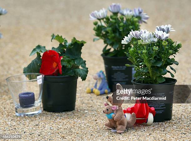 Toy kangaroo and floral tributes are placed in the drive of a house in New Malden on April 23, 2014 in south London, England. Police say that a 43...