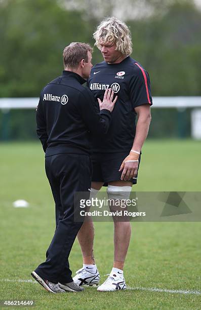 Mark McCall the Saracens director of rugby talks to Mouritz Botha during the Saracens training session held at the Saracens media day held at their...