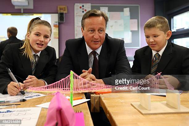 Prime Minister David Cameron speaks to pupils during a visit to Corby Technical School on September 2, 2015 in Corby, England. Mr Cameron used the...