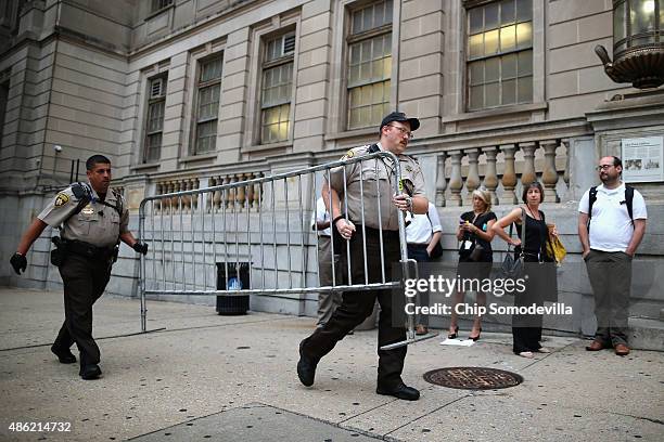 City Sheriff's deputies place barricades in front of the Baltimore City Circuit Courthouse East where pre-trial hearings will be held for six police...