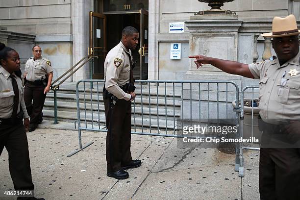 City Sheriff's deputies place barricades in front of the Baltimore City Circuit Courthouse East where pre-trial hearings will be held for six police...