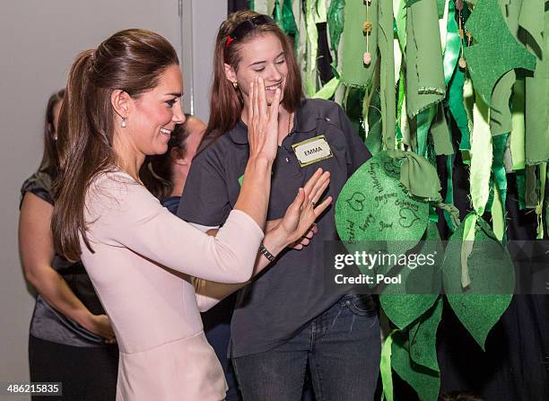 Catherine, Duchess of Cambridge ties on a leaf to the Mental Health Tree during her visit to the youth community centre, The Northern Sound System,...