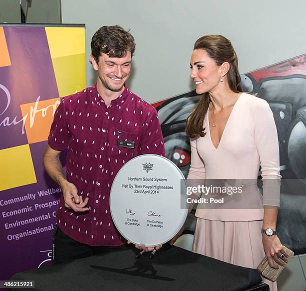 Nick O'Connor and Catherine, Duchess of Cambridge are seen after she signs a drum skin during their visit to the youth community centre, The Northern...