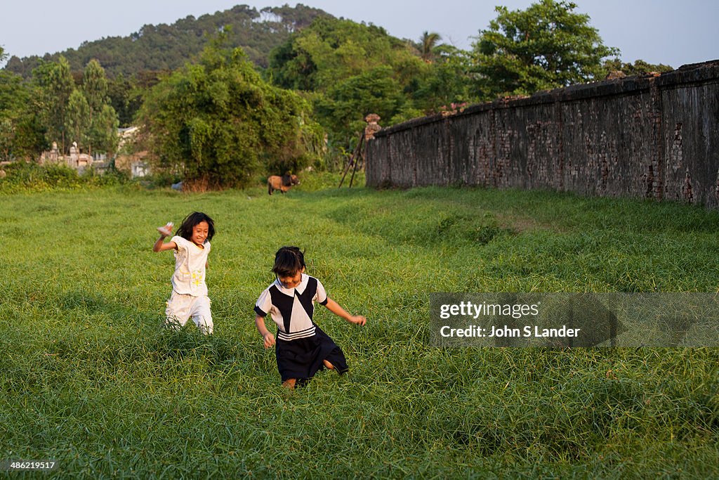 Spirited Vietnamese children playing in a field...
