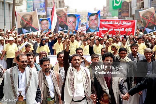 Yemeni demonstrators shout slogans as they march from Sana'a University to the Ministry of Oil and Minerals during a protest against power cuts and...