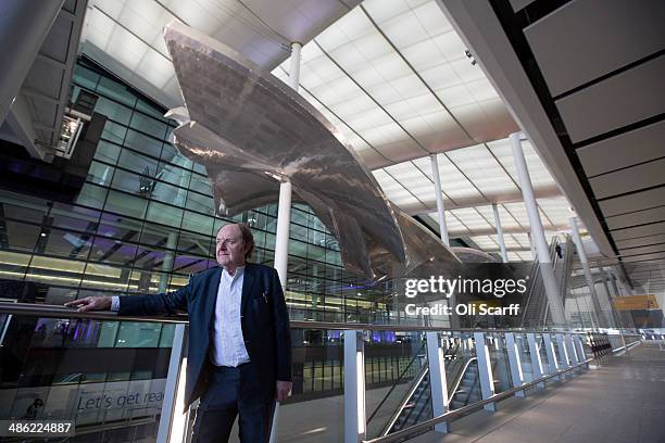 British artist Richard Wilson poses with his new artwork 'Slipstream' in Terminal 2 of Heathrow airport on April 23, 2014 in London, England. The...