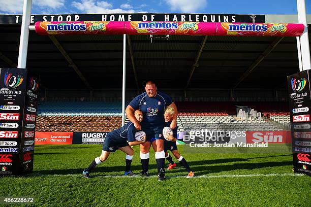 Former England's Strongest Man Terry Hollands poses for a photo with dancer Louie Spence and Made In Chelsea actor Jamie Laing during the Rugby Aid...