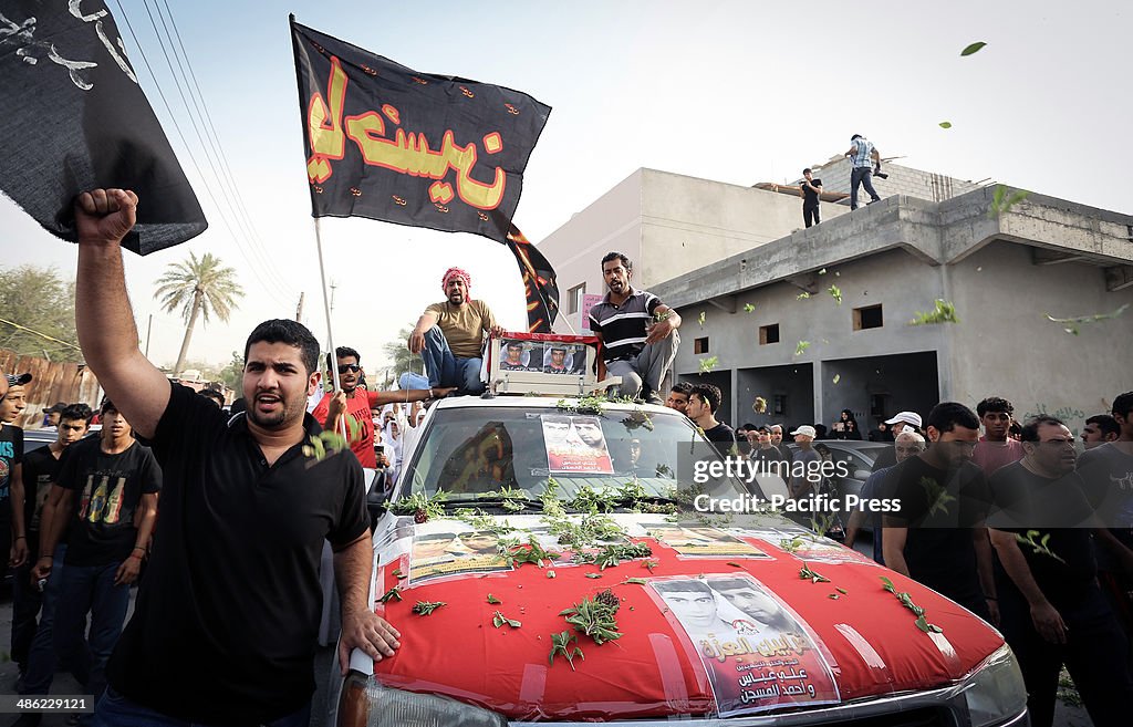 Bahraini mourners participate in the funeral of the martyrs...