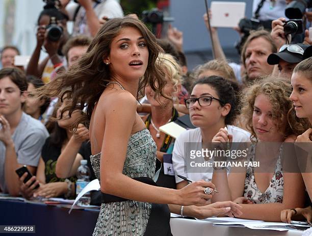 Festival hostess, Italian actress and model Elisa Sednaoui signs autographs as she arrives for the opening of the 72nd Venice International Film...