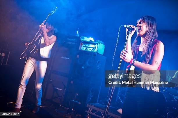Frontwoman Ann-Sofie Hoyles and bassist Matteo Gambacorta of Swedish rock group Spiders performing live on stage at Hard Rock Hell VI : A Fistful Of...