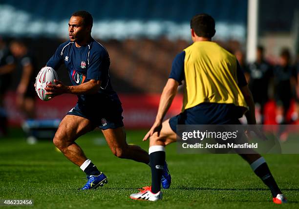 Jason Robinson avoids a tackle from Harry Judd looks on during the Rugby Aid 2015 celebrity rugby match media session at Twickenham Stoop on...