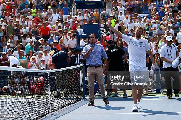 Mardy Fish of the United States waves to the crowd after losing his Men's Singles Second Round match against Feliciano Lopez of Spain on Day Three of...