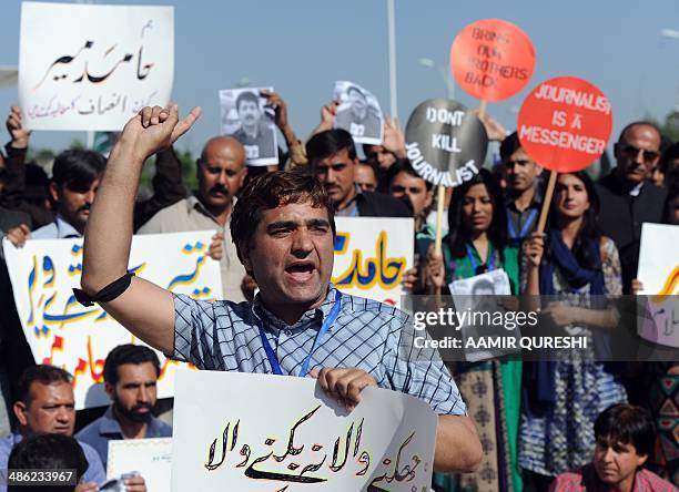Pakistani journalists shout slogans during a protest against the attack on Geo television journalist Hamid Mir by gunmen in Islamabad on April 23,...
