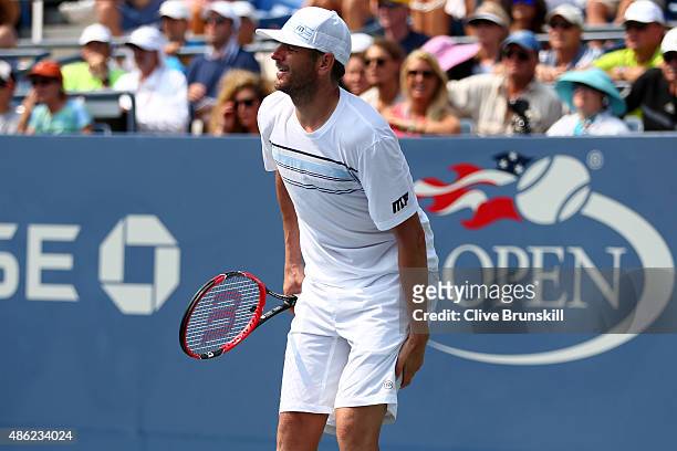 Mardy Fish of the United States holds his leg while playing against Feliciano Lopez of Spain during their Men's Singles Second Round match on Day...