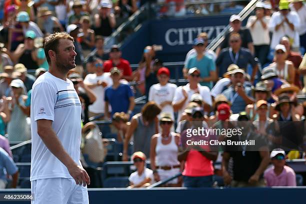 Mardy Fish of the United States walks off of the court after losing his Men's Singles Second Round match against Feliciano Lopez of Spain on Day...