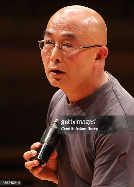 Chinese poet Liao Yiwu has a drink as he waits for the beginning of a panel discussion at the Berlin International Literature Festival on September...
