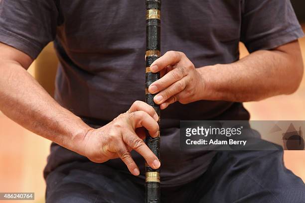 Chinese poet Liao Yiwu practices his xiao, or Chinese flute, as he waits for the beginning of a panel discussion at the Berlin International...