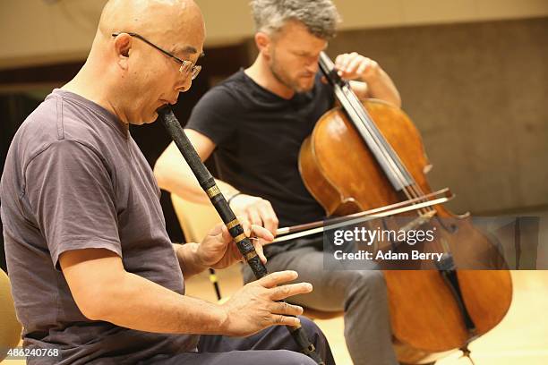 Chinese poet Liao Yiwu practices his xiao, or Chinese flute, as he waits for the beginning of a panel discussion at the Berlin International...