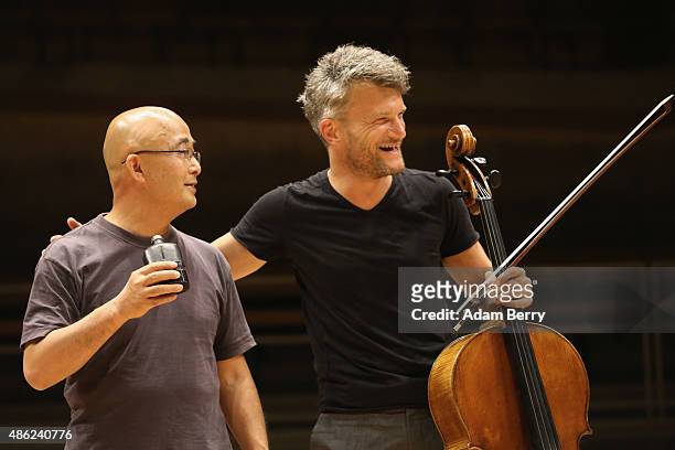 Chinese poet Liao Yiwu has a drink while joking around with cellist Marcus Hagemann as he waits for the beginning of a panel discussion at the Berlin...