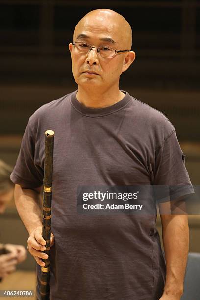 Chinese poet Liao Yiwu holds his xiao, or Chinese flute, as he waits for the beginning of a panel discussion at the Berlin International Literature...