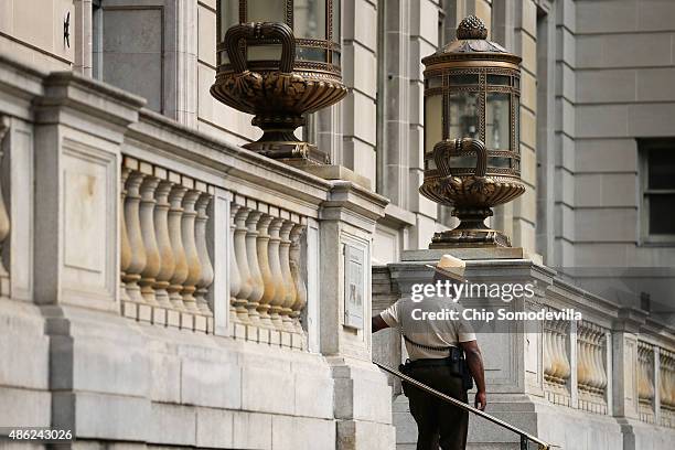 City Sheriff's deputies stand guard in front of the Baltimore City Circuit Courthouse East where pre-trial hearings are being held for six police...