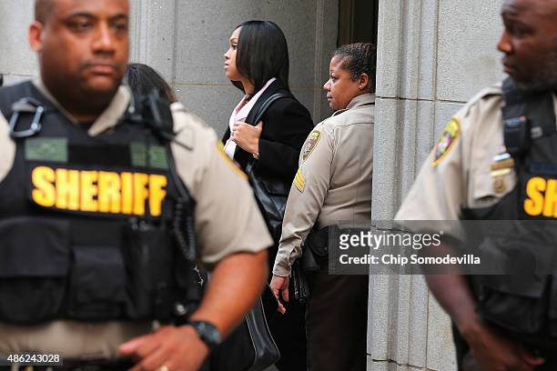 City Sheriff's deputies form a perimeter around State's Attorney for Baltimore Marilyn Mosby as she leaves the Baltimore City Circuit Courthouse East...