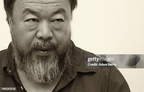 Chinese dissident artist Ai Weiwei pauses as he signs books for fans after a panel discussion at the Berlin International Literature Festival on...