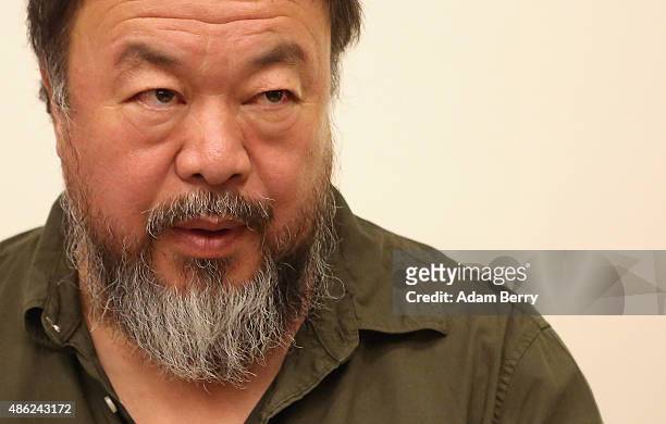 Chinese dissident artist Ai Weiwei pauses as he signs books for fans after a panel discussion at the Berlin International Literature Festival on...