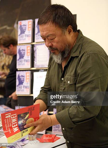 Chinese dissident artist Ai Weiwei signs books for fans after a panel discussion at the Berlin International Literature Festival on September 2, 2015...
