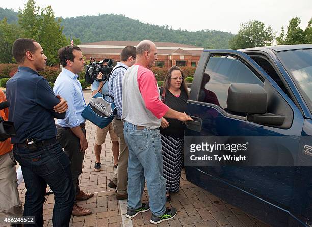 Rowan County Clerk of Courts Kim Davis is escorted to her vehicle as she is questioned by the media about the issue of her not issuing marriage...