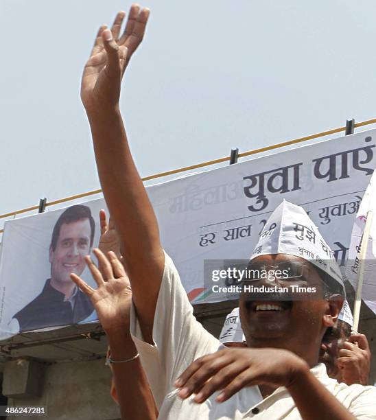 Leader Arvind Kejriwal waves to supporters during road show while heading to the district collectors office to file his nomination papers for ongoing...