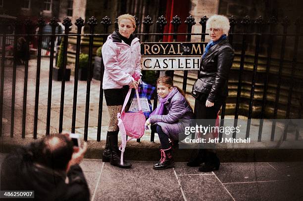 Tourists stop for a photograph near to Edinburgh Castle on the Royal Mile on April 23, 2014 in Edinburgh, Scotland. A referendum on whether Scotland...