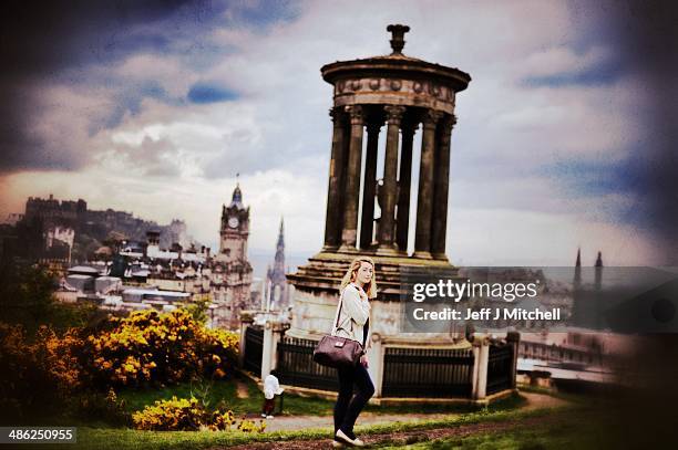 Woman walks past the Dugald Stewart Monument on Calton Hill on April 23, 2014 in Edinburgh, Scotland. A referendum on whether Scotland should be an...