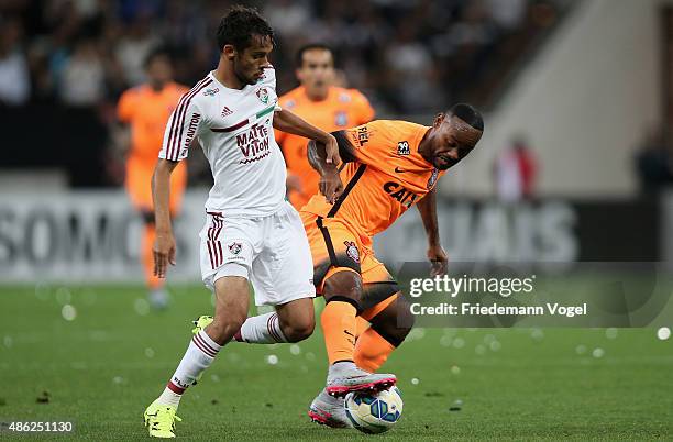 Vagner Love of Corinthians battles for the ball with Gustavo Scarpa of Fluminense during the match between Corinthians and Fluminense for the...