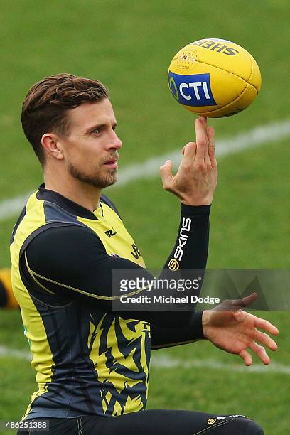 Brett Deledio of the Tigers spins a ball on hs fingers during a Richmond Tigers AFL training session at the ME Centre on September 3, 2015 in...