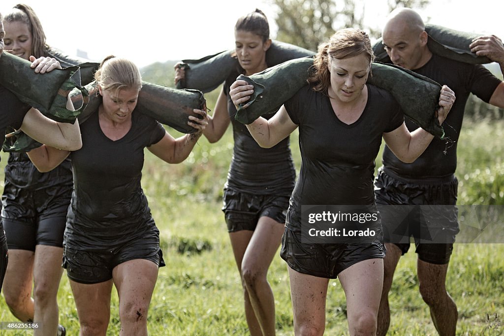Group of friends jogging outdoors carrying weights