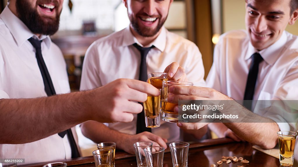 Men toasting in the bar