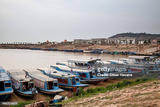 Tourist boats are parked in the floating village of Chong Kneas where the development of a new tourist dock has forced residents to move inland on...