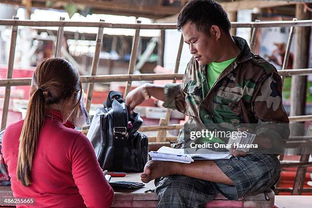 Man counts dollar bills near the fishing docks of Chong Kneas on April 23, 2014 in Siem Reap, Cambodia. Fishing in Chong Kneas is controlled by a few...