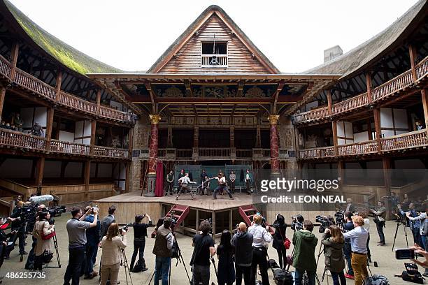 Members of the cast of a new touring production of William Shakespeare's "Hamlet" perform during a photocall at the Globe theatre in London on April...