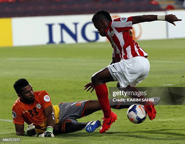 S al-Jazira forward Ahmed Rabeea tries to dribbles past Saudi's al-Shabab goalkeeper Mohammed Al-Owais during their AFC Champions League at the...