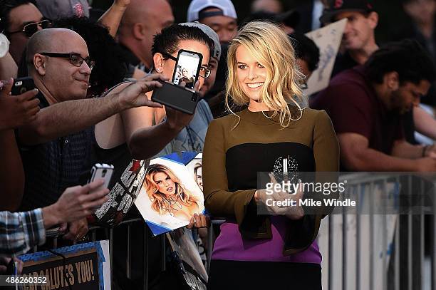 Actress Alice Eve poses for selfies with fans and signs autographs during the premiere of Radius and G4 Productions' "Before We Go" at ArcLight...