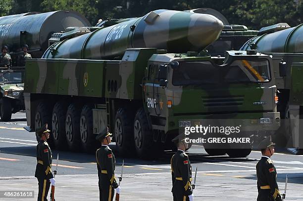 Military vehicles carrying DF-26 ballistic missiles participate in a military parade at Tiananmen Square in Beijing on September 3 to mark the 70th...