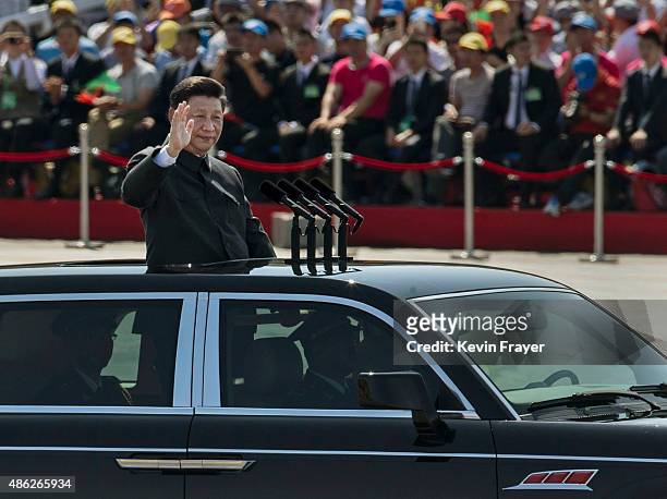 Chinese president and leader of the Communist Party Xi Jinping rides in an open top car as he greets soldiers and others in front of Tiananmen Square...