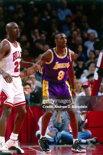 Michael Jordan of the Chicago Bulls stands against Kobe Bryant of the Los Angeles Lakers on December 17, 1996 at the United Center in Chicago,...